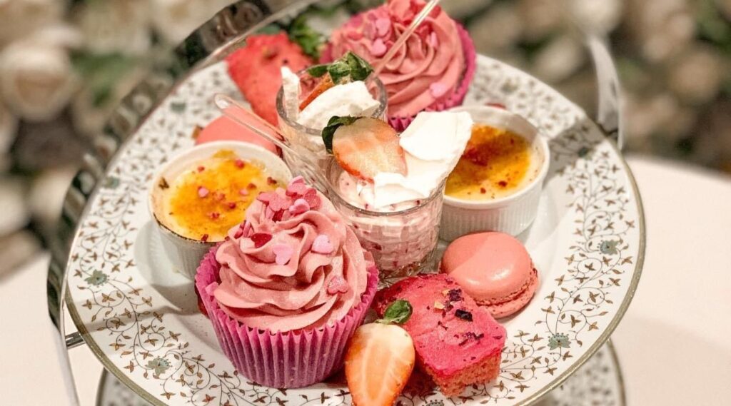 Afternoon tea near Norwich at Glen Lodge with tiered stand of sandwiches, scones and cakes served with prosecco on the terrace